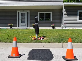 Neighbours on Delevan Crescent in Tillsonburg laid flowers in memory of a 54-year-old technician who they say fell to his death from a ladder Monday when he was working on utility wires in front of one of the homes. Photo taken on Tuesday June 14, 2022.  (CALVI LEON/The London Free Press)