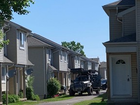London police deployed an armoured vehicle and tactical officers at a townhouse unit at Shelborne Street on Saturday, June 11, 2022, while investigating a report of gunfire at nearby commercial plaza. (Jane Sims/The London Free Press)