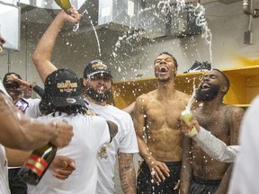 The London Lightning celebrate their  NBL championship after a 97-96 win over the  Kitchener-Waterloo Titans at The Aud in Kitchener on Wednesday. (Derek Ruttan/The London Free Press)