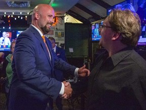 Terence Kernaghan is congratulated by Matt Nicolaidis at Wink's in downtown London on Thursday, June 2, 2022.  Kernaghan was re-elected as MPP in London North Centre. (Derek Ruttan/The London Free Press)