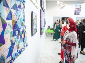 Maria Ur Rahman (foreground) and Sabena Islam admire artwork during the launch of a community art gallery dedicated to the Afzaals at the London Muslim Mosque on Monday, June 6, 2022. (Derek Ruttan/The London Free Press)