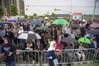 Hundreds of people gather at the intersection of Hyde Park and South Carriage roads for the Our London Family Vigil in honor of the Afzaal family in London on Monday June 6, 2022. The vigil was cut short by heavy rain and the possibility of severe thunderstorms.  (Derek Ruttan/The London Free Press)