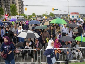 Hundreds of people attend the Our London Family Vigil in honour of the Afzaal famiy at the intersection of Hyde Park and South Carriage roads in London on Monday, June 6, 2022. The evening vigil ended earlier than planned because of heavy rain and the possibility of severe thunderstorms. (Derek Ruttan/The London Free Press)