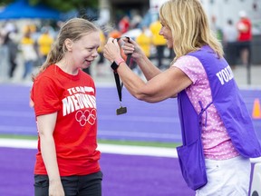 Amelia Howe of Medway receives a gold medal from Connie Visser after winning the senior girls 80-metre sprint on the second day of the Thames Valley District school board Special Olympics at Western Alumni Stadium in London on Thursda,y June 9, 2022. Close to 1,000 students from the board's elementary and high schools are competing over three days. (Derek Ruttan/The London Free Press)