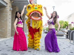 Luna Wilson, left, and Betsy Esbaugh, of Rising Moon Belly Dance Studio, and Alex Tang, of the London Chinese Freemasons' lion dance team, are just some of the performers set for Friday's free Canada Day London bash downtown. (Derek Ruttan/The London Free Press)