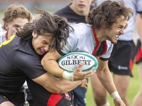Collingwood's Tosh Dmitrov holds on to Medway ball carrier Matt Soares in their OFSAA AAA rugby championship game on Thursday June 2, 2022. Medway, ranked No. 2, scored one try in the first half and two in the second to win 19-5 over 15th-ranked Collingwood. Medway is playing host to the tournament, with games played at John Paul II, Beal, St. Thomas Aquinas and Medway. (Mike Hensen/The London Free Press)