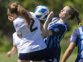 East York Collegiate Institute's Vicky Babatsikos, left, and Lucas secondary school's Brooklyn Anderson collide going for a pass as the high school teams meet on Day 2 of the Ontario Federation of School Athletic Associations AAA girls soccer championship in London on Friday June 3, 2022. The visitors went on to beat the tournament hosts, 2-0. (Mike Hensen/The London Free Press)