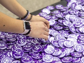 Sophia Abdulkarim, 13, sorts through Our London Family buttons at Oakridge secondary school in London, where a march began to honour the one-year anniversary of the alleged hate-motivated killings of the Afzaal family. Photograph taken on Sunday June 5, 2022. 
Mike Hensen/The London Free Press