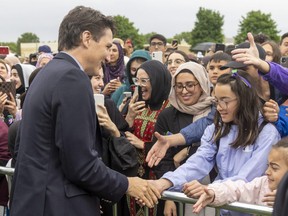 Prime Minister Justin Trudeau greets some of the more than 2,000 people who gathered in northwest London to march in honour of the first anniversary of the alleged hate-motivated killing of the Afzaal family. Photograph taken on Sunday June 5, 2022. 
Mike Hensen/The London Free Press