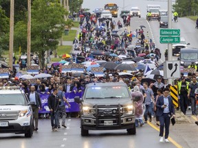Marchers stream along Oxford Street, heading from Oakridge secondary school to the London Muslim Mosque to mark the first anniversary of the alleged hate-motivated killing of four members of the Afzaal family in London. The march was being led by students and Prime Minister Justin Trudeau. Photograph taken on Sunday June 5, 2022. Mike Hensen/The London Free Press