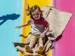 Julian Sleegers, 3, smiles at his mom as he slides down the big slide at the London Children's Festival in Victoria Park on Friday June 17, 2022. (Mike Hensen/The London Free Press)