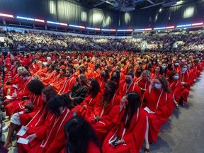 Fanshawe College grads in red fill the floor of Budweiser Gardens as they take part in the college's first in-person graduation since 2019 on Monday, June 20, 2022. More than 7,000 students are graduating in ceremonies over three days. (Mike Hensen/The London Free Press)