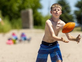 Noah Howley, 11, from Strathroy was playing catch on main beach in Port Stanley with his brother on Friday June 24, 2022. (Mike Hensen/The London Free Press)