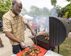 Kwabena Johnson from Woodstock prepares jerk chicken at the London International Food & Drink Festival in Victoria Park in London.