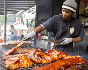 Carlos McPherson of Jack the Ribber coats a rack of ribs at the London International Food & Drink Festival in Victoria Park.