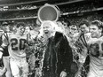 Queen's Golden Gaels football coach Doug Hargreaves gets doused with water in the last few seconds of Queen's 31-0 victory over the St. Mary's Huskies in the Vanier Cup at the Sky Dome in Toronto on Saturday November 21, 1992. (Ian MacAlpine/Postmedia Network)