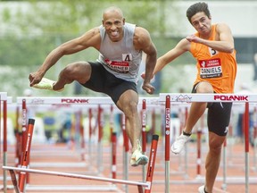 Damian Warner’s left foot catches the hurdle during 110-metre hurdle at  Harry Jerome Track Classic at Swangard Stadium in Burnaby, BC., June 14, but he won in the event 13.68 seconds.  Warner has pulled out of the national championships due to a sore knee, but intends to compete in the world championships
(Arlen Redekop / Postmedia)