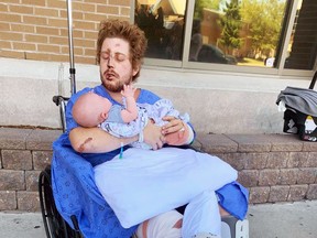 Clayton Ball holds his newborn son Briar a couple of days after the then-24-year-old Sarnia resident was injured in a hit-and-run crash on Aug. 21, 2020. (GoFundMe)