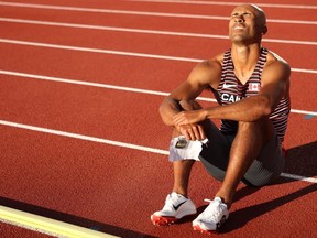 Damian Warner grimaces after an injury forced him out of the men's decathlon during the 400-metre race at the World Athletics Championships in Eugene, Ore., on Saturday. (Patrick Smith/Getty Images)