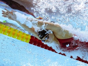London's Maggie MacNeil powers to victory in the women's 100 metre butterfly final at the Sandwell Aquatics Centre at the Commonwealth Games in Birmingham, England, on July 30, 2022. (Photo by Oli SCARFF / AFP via Getty Images)