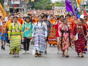 Indigenous women lead thousands of people north on Richmond Street from Victoria Park in the Turtle Island Healing Walk in London, on Friday. Thousands of people travel north on Richmond Street from Victoria Park while participating in the Turtle Island Healing Walk in London on Friday. The walk, on Canada Day, remembers the Indigenous children who attended residential schools, thousands of whom died at the institutions and were left in forgotten graves. (Derek Ruttan/The London Free Press)