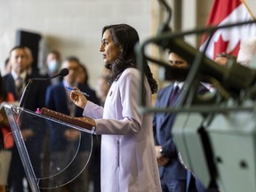 Canadian Defense Minister Anita Anand stands in front of two armoured combat support vehicles at General Dynamics Land Systems in London, on Thursday, July 7, 2022. Anand announced that Canada was sending up to 39 of the versatile vehicles made in London to help Ukraine in their war against the invading Russian army. (Mike Hensen/The London Free Press)