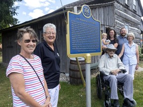 Area descendants of Peter Butler, who escaped slavery in the U.S. to become an original resident of the Wilberforce settlement in the 1820s, fete the installation of an updated plaque at the site in Lucan-Biddulph Township, north of London, Thursday. They are Wendy Hiscox, left, Marlene Thornton, Edward Butler and his wife Anneliese Butler. In back are Rachel Butler, holding daughter Brynn, and Rachel's husband, Allan Baxter. (Mike Hensen/The London Free Press)