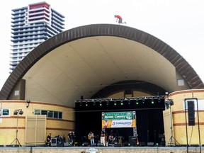 A man climbed the bandshell in Victoria Park during the opening act for the Home County Music and Arts Festival in London. Photo taken Friday July 15, 2022. Mike Hensen/The London Free Press