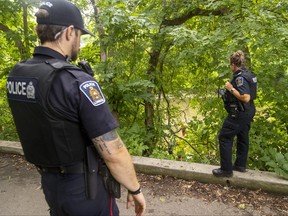 London police officers work near the south branch of the Thames River between York and King streets near downtown London after a body was pulled from the water on Wednesday July 20, 2022. Mike Hensen/The London Free Press