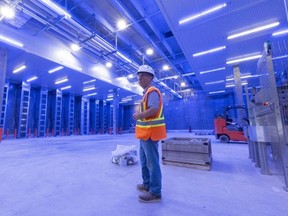 Lou Cappa, the site leader for Maple Leaf Foods who is guiding construction of the company's new chicken processing plant on Wilton Grove Road in London, stands in a blue-lit area of the facility where chickens will be calmed before they are processed. Photograph taken on Thursday, July 21, 2022. Mike Hensen/The London Free Press