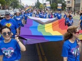 The Royal Bank contingent brought a large Progress Pride flag as they marched at the Pride Parade. (Mike Hensen/The London Free Press)