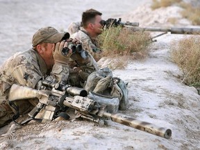 A Canadian sniper team scan the landscape during an Afghan-led operation on 28 April 2006. Of the five farthest sniper kills ever recorded, three were made by Canadians.