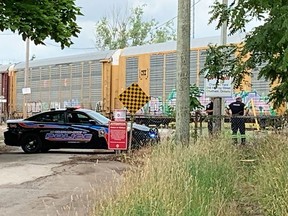 A Chatham-Kent police officer and a paramedic are seen at the Canadian Pacific Railway tracks at the end of Murray Street in Chatham following a train crash around 3:30 p.m. on Wednesday July 6, 2022. PHOTO Ellwood Shreve/Chatham Daily News