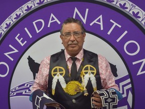 Todd Cornelius, the newly elected chief of Oneida Nation of the Thames, southwest of London, holds the Oneida Belt in his left hand and Hiawatha Wampum Belt in his right. (Calvi Leon/The London Free Press)