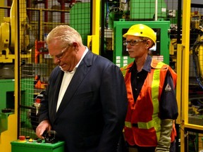Ontario Premier Doug Ford was at the Dyna-Mig auto-parts manufacturing plan in Stratford Wednesday morning to announce a provincial investment of $5 million to provider free training for 500 people from underrepresented groups across the province to prepare them for jobs in the automotive sector. Pictured, Ford learns to use a piece of equipment on the factory floor. (Galen Simmons/Postmedia Network)