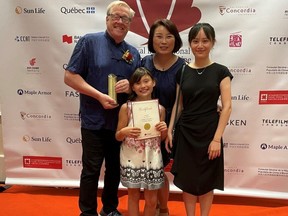Stratford director Craig Thompson celebrates winning the Best Director award for his documentary, Footsteps of Bethune, alongside his wife, Koi Thompson, their daughter, Jaden Thompson, and Lingxi Cui, one of the film's editors, at the Canada China International Film Festival in Montreal last month.