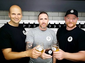 Brothers-in-law Claudio Palleschi, left, David Kruger and Scott Dunn toast good times and good beer as they launch Point Brewing in Point Edward. (POINT BREWING)