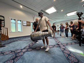 NHL star Nazem Kadri carries the Stanley Cup inside the London Muslim Mosque before a public event and parade in London on Saturday Aug. 27, 2022. (Jonathan Juha/The London Free Press)