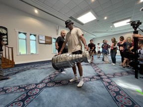 NHL star Nazem Kadri carries the Stanley Cup inside the London Muslim Mosque before a public event and parade in London on Saturday Aug.  27, 2022. (Jonathan Juha/The London Free Press)