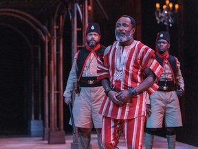 Anthony Santiago (foreground) is Elesin, the King's horseman,  Matthew Kabwe, left,  and Pulga Muchochoma are constables in Death and the King’s Horseman at the Stratford Festival until Oct. 29, 2022.