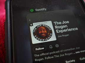 This illustration photo shows the Spotify page for "The Joe Rogan Experience" podcast displayed on a smart phone in Washington, DC on February 7, 2022.  (Photo by MANDEL NGAN / AFP)