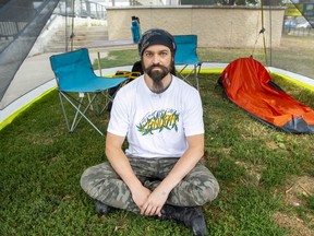 Dan Oudshoorn of #TheForgotten519 coalition sits in a tent outside London city hall on Tuesday, Aug. 2, 2022, after beginning a hunger strike to back the coalition's demands for the city to make changes to its homelessness strategy. (Derek Ruttan/The London Free Press)
