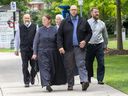 Herbert Hildebrandt, front, walks to court accompanied by family members, including his father Pastor Henry Hildebrandt, left.  in St. Thomas on Wednesday Aug.  3, 2022, for Herbert Hildebrandt's assault trial.  (Derek Ruttan/The London Free Press)