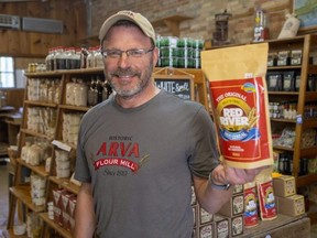 Mark Rinker, co-owner of Arva Flour Mill, holds a bag of Red River cereal made in the mill in Arva on Friday, Aug. 12, 2022. Arva Flour Mill acquired the Red River cereal brand from Smuckers Foods of Canada Corp., which stopped producing the cereal last year. (Derek Ruttan/The London Free Press)