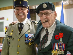 George Beardshaw gives a wink after receiving the National Order of the Legion of Honour medal (beside his poppy) from France's deputy defence attache Colonel Roger Vandomme in London on Sunday Aug. 28, 2022. The military veteran landed on Juno Beach on D-Day and helped liberate France from Nazi Germany. He was also celebrating his upcoming 99th birthday. Derek Ruttan/The London Free Press/Postmedia Network