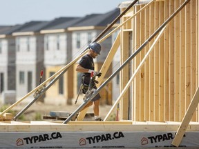 Jamie Daugharty of Willow Bridge Construction works on framing a house being built near Wharncliffe Road South in London. Photograph taken on Monday, Aug. 15, 2022.  Mike Hensen/The London Free Press