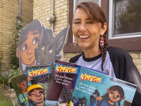 Indigenous author and publisher Kristi White holds her series of books 'The Adventures of Jay and Gizmo.' Photograph taken on Friday August 26, 2022. Mike Hensen/The London Free Press