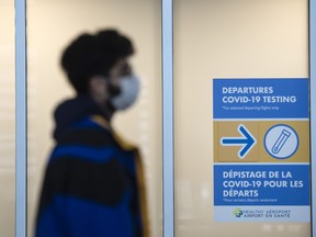 A traveller makes their way to the check-in area at Toronto Pearson International Airport Terminal 1 during the COVID-19 pandemic in Toronto, December 15, 2021.