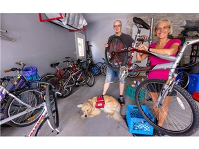 A.J. McCallum and his mom Heather McCallum, along with Leo, A.J.'s service dog, stand among some of the bikes they are repairing and donating to migrant farm workers in SouthWestern Ontario through two local churches. A.J. does all the wrench work, while Heather does a lot of the legwork collecting and distributing the bikes (Mike Hensen/The London Free Press)