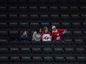 Fans take a selfie as they watch the United States take on Finland during first period IIHF World Junior Hockey Championship exhibition action in Edmonton on Thursday, December 23, 2021.